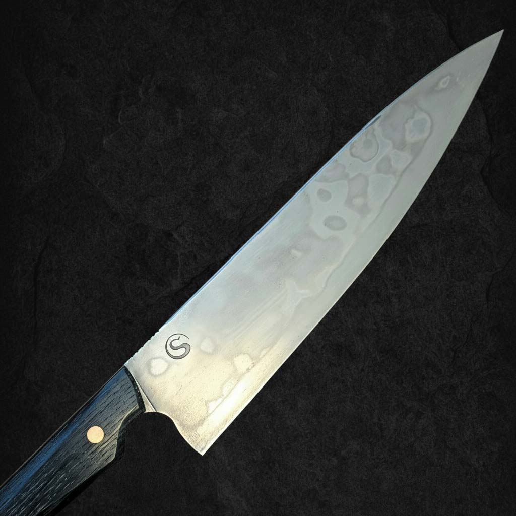 Handsmidd Gyuto kockkniv 'Mr Leopard-skin' i kolstål med vacker auto-hamon och skaft av sumpek. Detalj knivblad